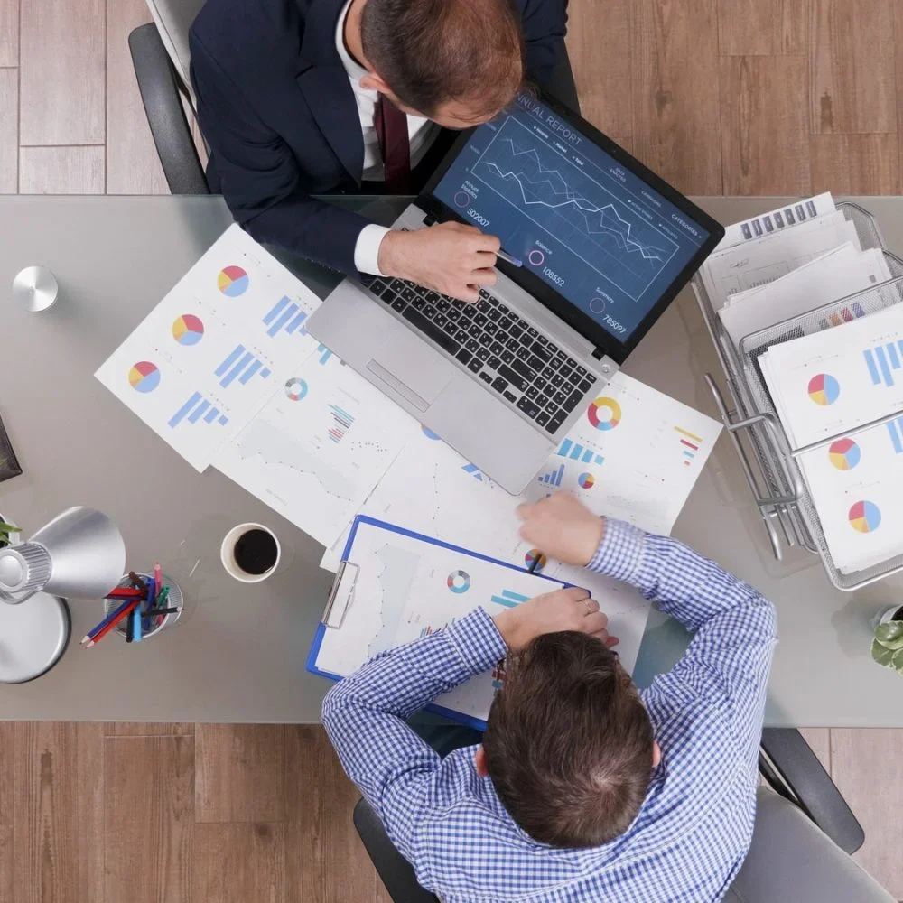 top-view-of-businessmen-analyzing-management-statistics-while-working-at-company-investments-rf6m022h6oitpz5vuey2vptblaxoeuw2mha8cbocnk